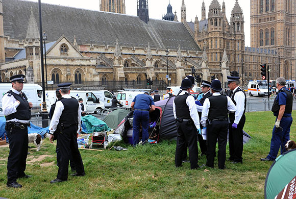 state opening: Police officers enter the Democracy camp in Parliament Square