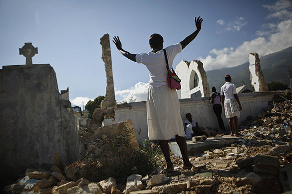 24 hours in pictures: Port-au-Prince, Haiti: Women pray next a church