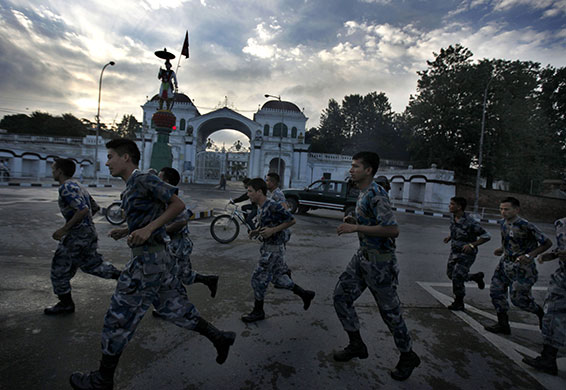 24 hours in pictures: Katmandu, Nepal: Policemen jog past Sinha Darba