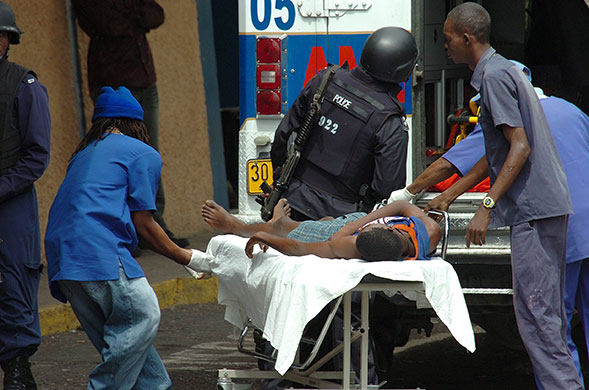 jamaica violence: An injured man is taken to the Public Hospital in Kingston, Jamaica