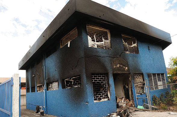 jamaica violence: The burnt-out police headquarters on Darling street, Kingston, Jamaica