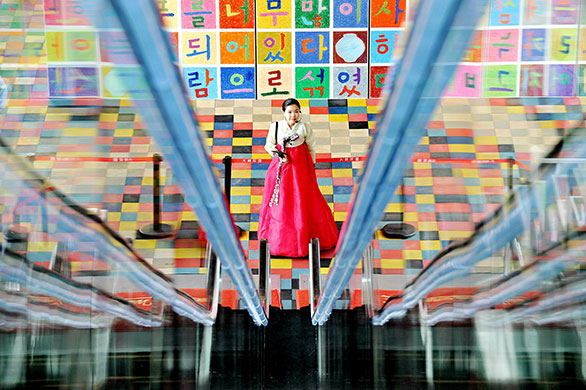 24 hours in pictures: Shanghai, China: A staff member of the South Korean pavilion