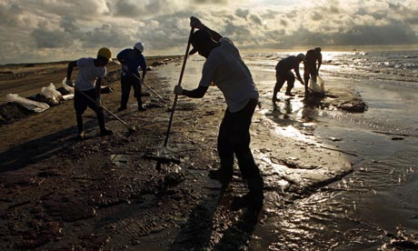 Workers hired by BP rake up oil in Louisiana
