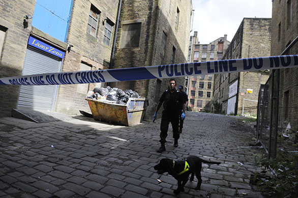 bradford murders: Police search an alley off Thornton Road in Bradford, northern England