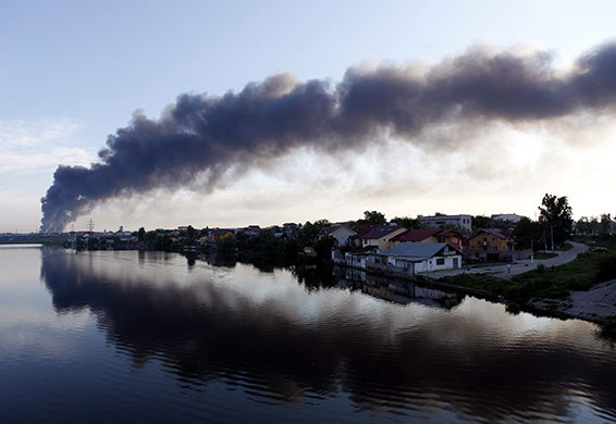 24 hours in pictures: Bucharest, Romania: A smoke column from a massive fire rises over the city