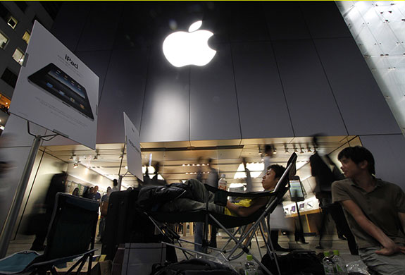 Week in Business: A man waits in line to purchase Apple's iPad in front of Apple Ginza store