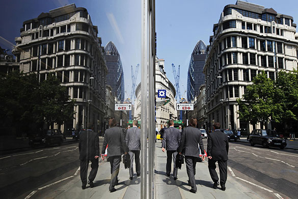 Week in Business: People walk in London's City financial district.