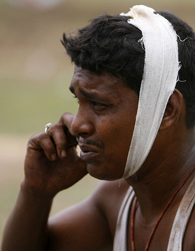 India train crash: An injured passenger speaks on a mobile phone