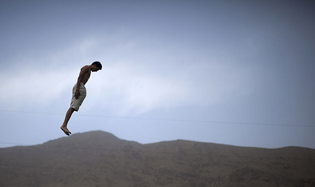 24 hours in pictures: A man jumps into a swimming pool in Kabul