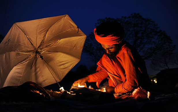 24 hours in pictures: Allahabad, India: A Sadhu offers eveing prayers at Sangam