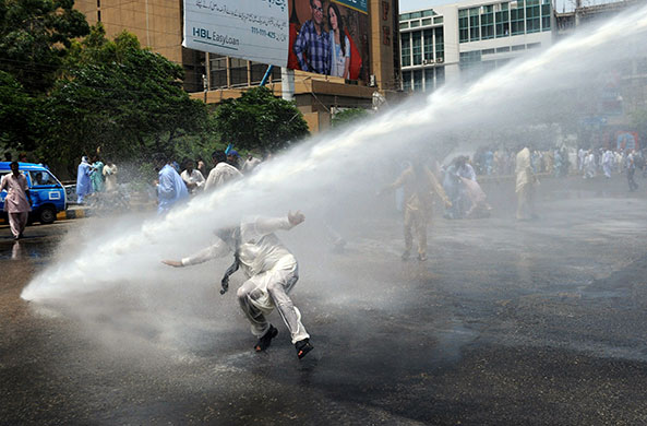 24 hours in pictures: Pakistani policemen use water cannons to disperse protesting teachers 