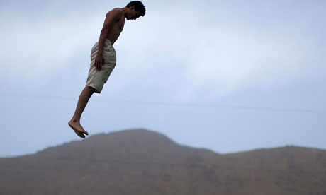 A man jumps into a swimming pool in Kabul
