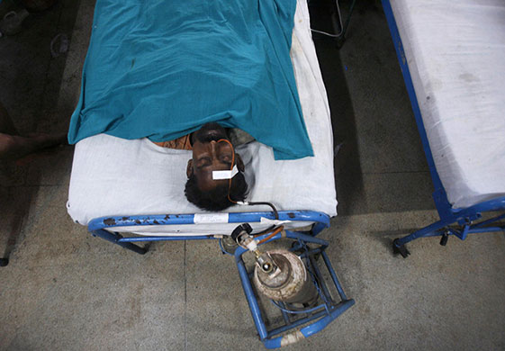 India train crash: An injured train passenger rests inside a hospital in Kharagpur town