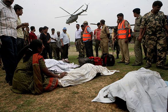 India train crash: A relative weeps as she identifies the dead body of a family member