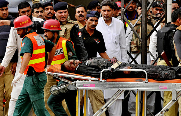 Lahore attack: Pakistani rescuers transport an injured police commando on a stretcher