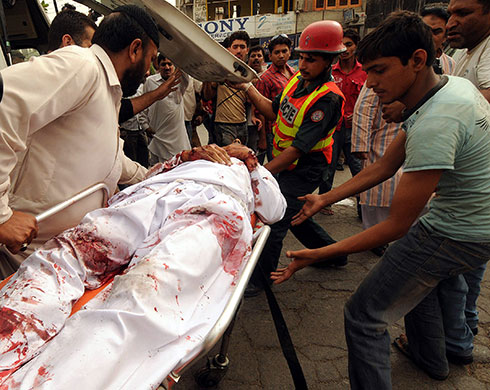 Lahore attack: Rescue workers remove bloodied victims after gunmen attacked a mosque