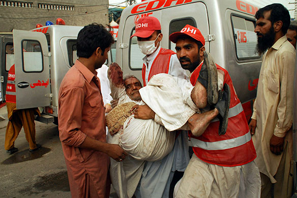 Lahore attack: Rescue personnel carry an injured man