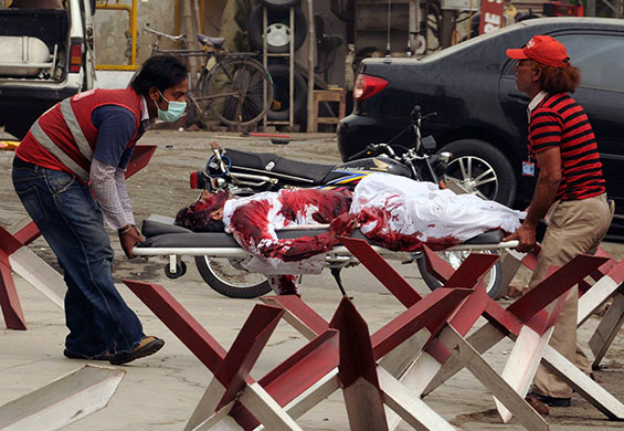 Lahore attack: Rescue workers shift bodies of the victims 
