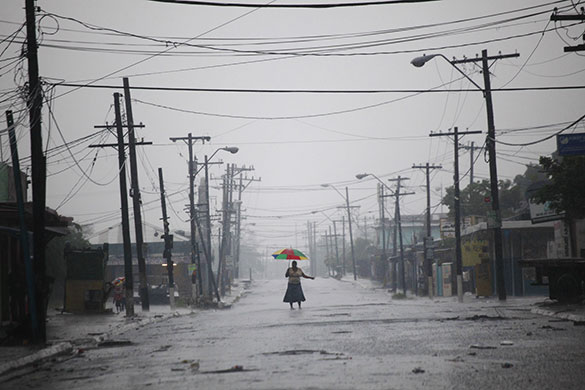 24 Hours in Pictures: A woman stands in the middle of an empty street in Tivoli Gardens