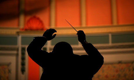 A conductor directs his musicians as they play in the Buxton Brass Band Festival.