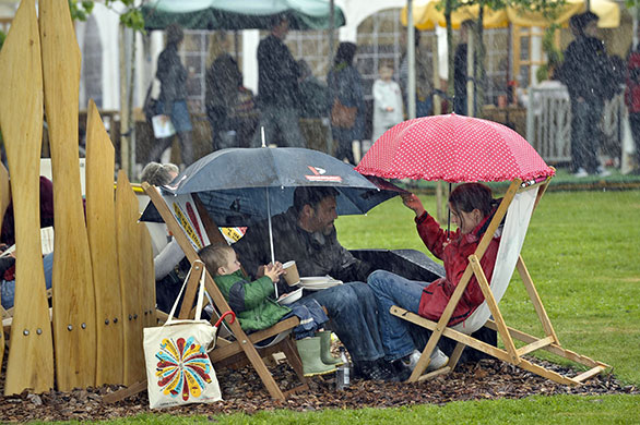 Hay Festival: People carry on and picnic during a very heavy downpour