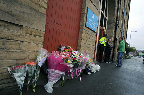 Bradford murders: Floral tributes are left outside the apartment of Stephen Griffiths