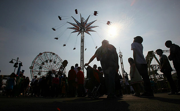 24 hours in pictures: New York, US: People gather on opening day of Luna Park amusement area