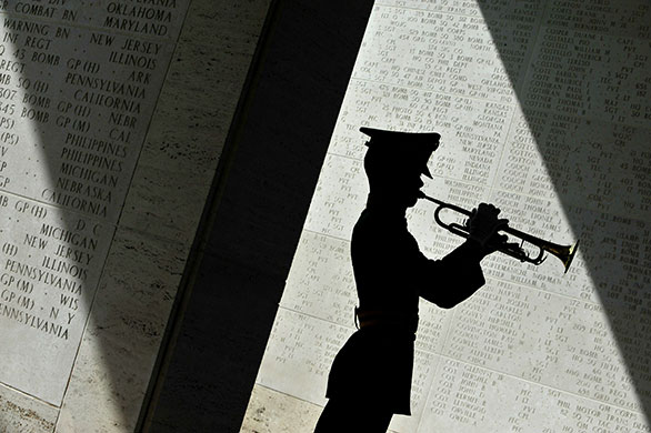 24 hours in pictures: Manila, Philippines: A soldier blows his bugle