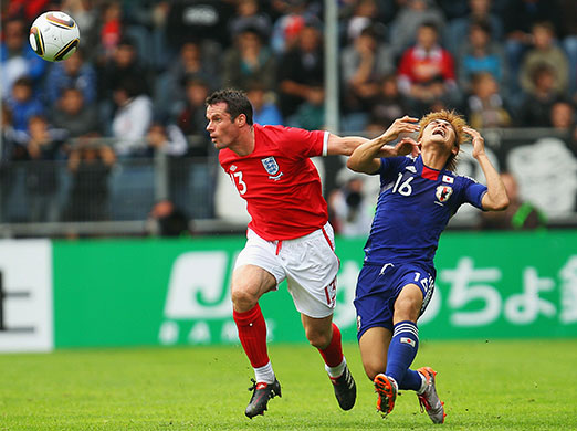 England v Japan friendly: Jamie Carragher wins the ball from Yoshito Okubo