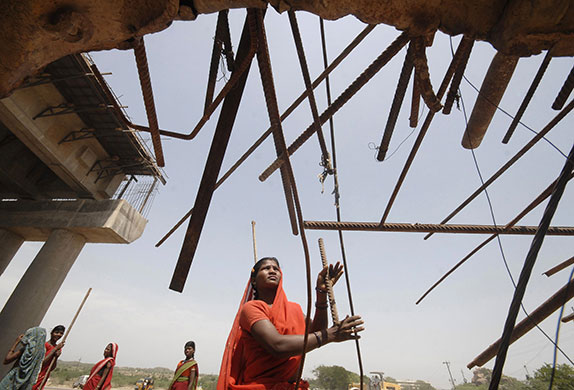24 hours: Hyderabad, India: A woman labourer works at a road construction site