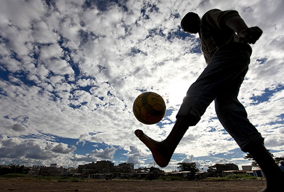 24 hours: Nairobi, Kenya: A boy juggles the ball during football practice