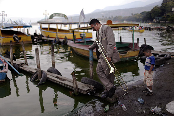 24 hours in pictures: Amatitlan, Guatemala: A musician and a boy