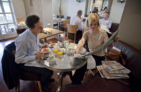 Campaigning with Clegg: Nick Clegg has breakfast in his hotel in Manchester with aide Lena Pietsch