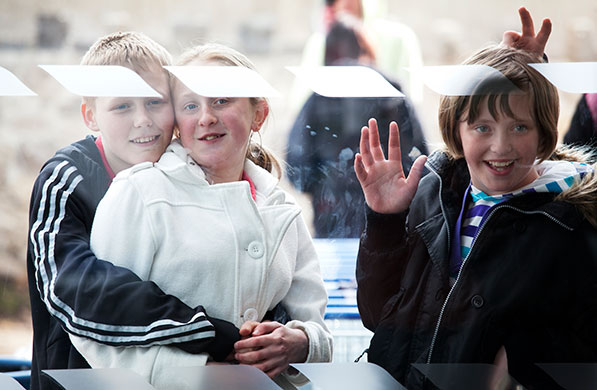 Cameron campaign trail: Children watch David Cameron as he visit Tesco in Delyn, North Wales