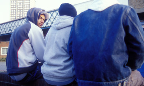 Teenage boys sit on a wall on