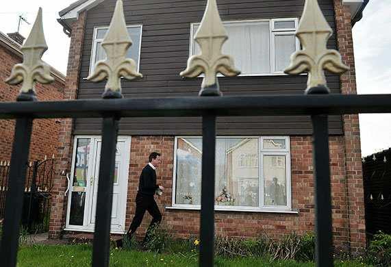 Daily election: David Cameron delivers leaflets as he canvasses potential votersin Hucknall