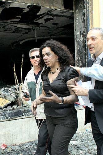 Greece Rioting: Firemen help a rescued bank employee of the Marfin-Egnatia Bank in Athens