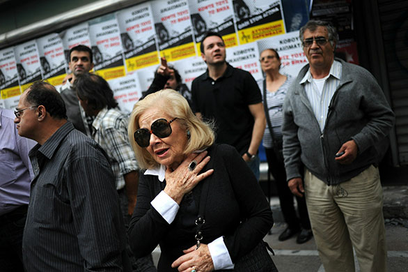 Greece Riots: A woman looks at the Marfin bank where three people were killed