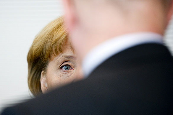 Week in business: German Chancellor Angela Merkel waits before a parliamentary group meeting