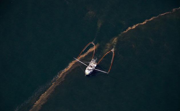 Deepwater Horizon oil rig: Oil spill reaches Louisiana coast: A shrimp boat hauling oil cleanup booms