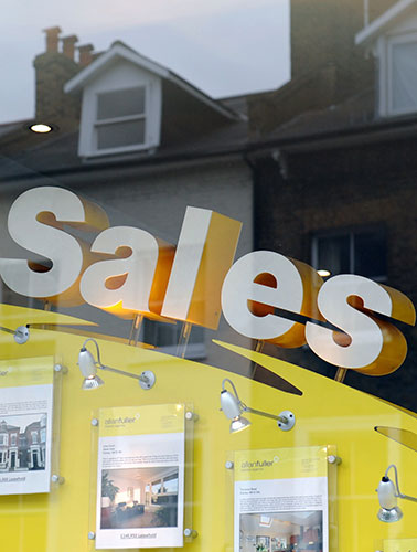 Week in business: Houses are reflected in the window of an estate agent in south London