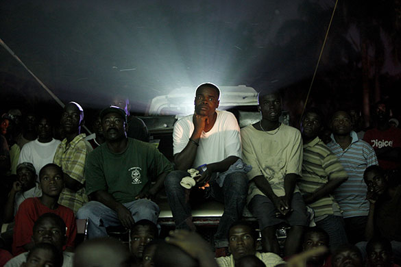 24 hours in pictures: Port au Prince: People watch a soccer game between Haiti and Argentina