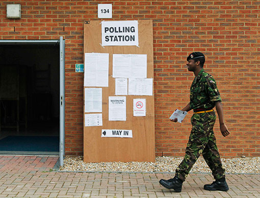 Voting updated: A soldier from the Royal Artillery arrives to cast his vote