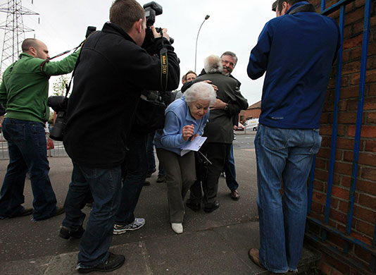 Voting updated: Voters and Sinn Fein President Gerry Adams at polling station