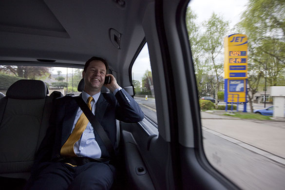 Clegg on polling day: Clegg chats on the phone