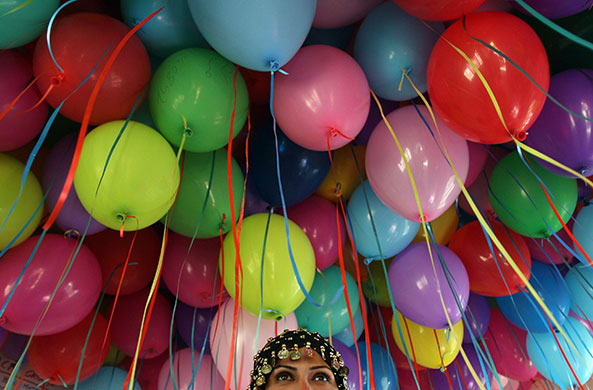 24 hours in pictures: Givat Zeev, West Bank: A woman prepares to release balloons