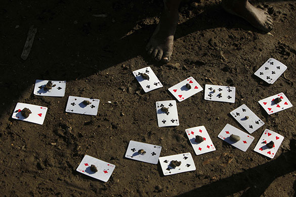 24 hours in pictures: Port au Prince, Haiti: A child plays with cards and stones in a camp