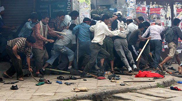 24 hours in pictures: Kathmandu, Nepal: Maoist supporters flee as policemen fire tear gas