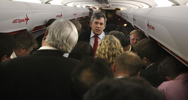 day after election night: Gordon Brown is surrounded by journalists on plane
