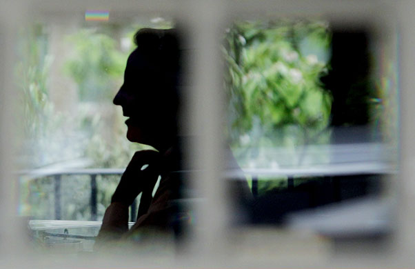 24 Hours in Pics: David Cameron adjusts his tie before leaving his home